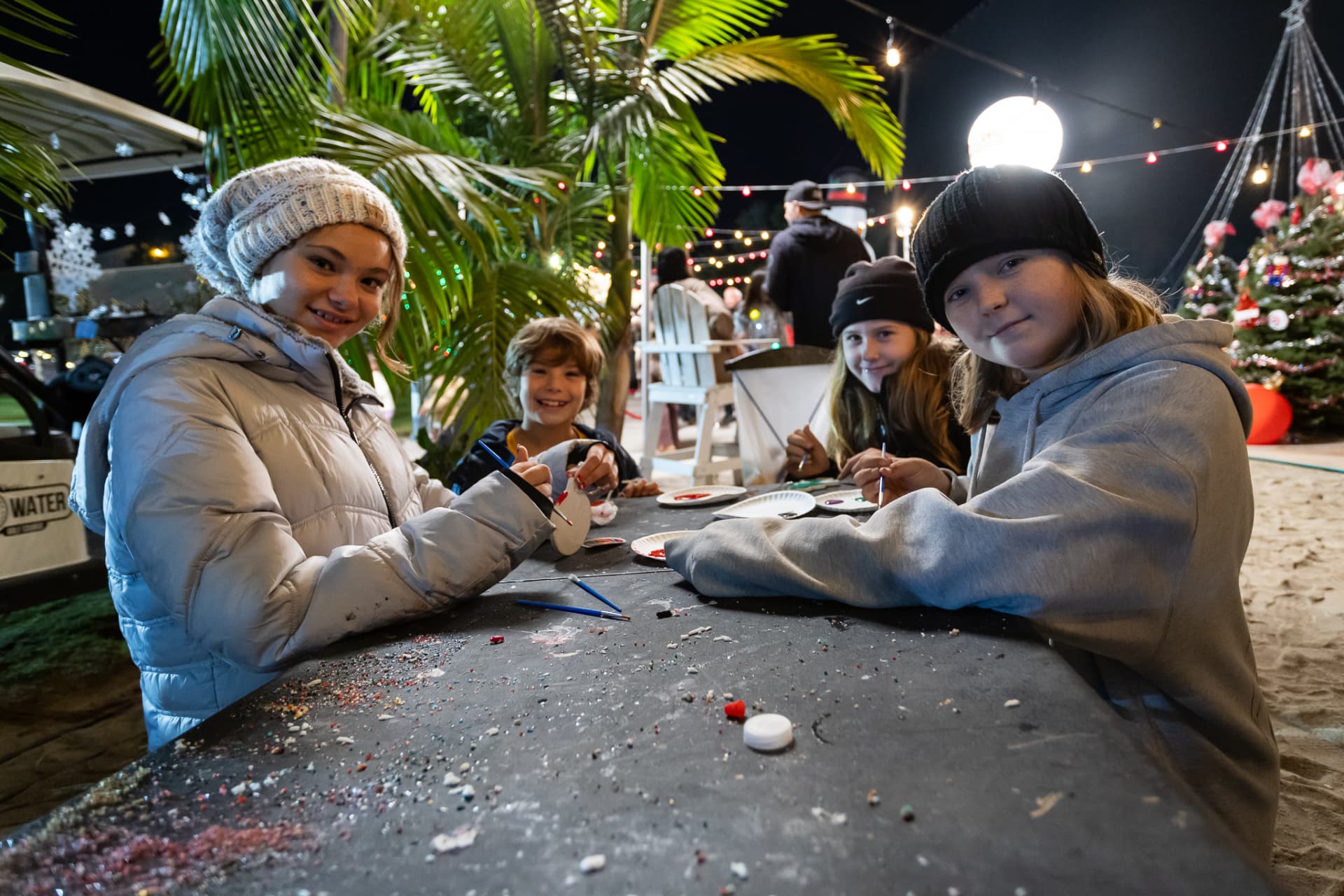 Kids painting ornaments at the SnowSide craft table