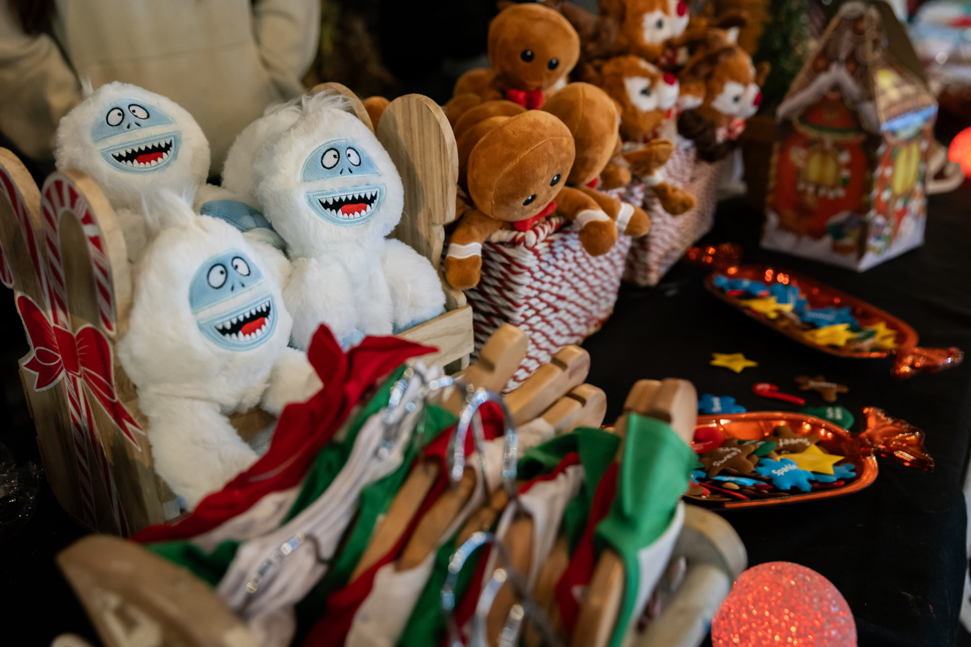 Holiday plush toys and gifts at a SnowSide vendor booth